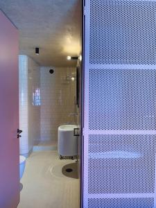 a bathroom with a shower and a tub and a sink at Oporto CoLiving Monte Ramalde in Porto