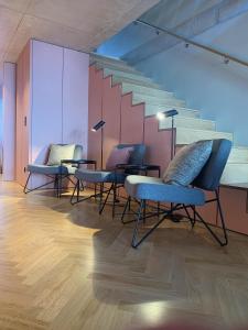 a group of chairs and tables in a room at Oporto CoLiving Monte Ramalde in Porto