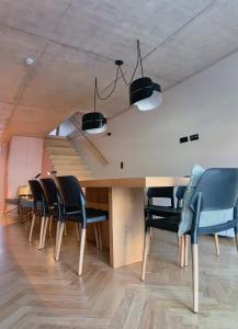 a dining room table with chairs and a staircase at Oporto CoLiving Monte Ramalde in Porto