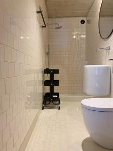 a bathroom with a white toilet and a mirror at Oporto CoLiving Monte Ramalde in Porto +22 photos