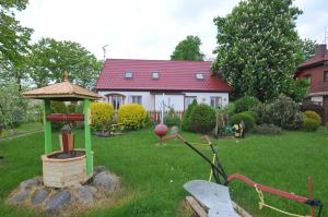 a yard with a gazebo in front of a house at Ośrodek Wczasowy Domino Bis in Dźwirzyno