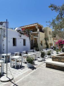 a group of tables and chairs in front of a building at Old Town Elpis Suite in Kos Town