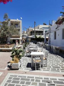 a group of tables and chairs on a patio at Old Town Euphoria Suite in Kos Town