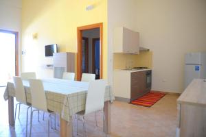 a kitchen with a table and chairs in a room at Agriturismo Mele in Copertino