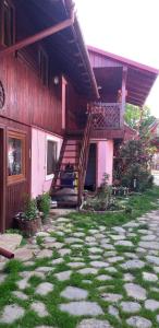 a house with a staircase on the side of it at Casa boierului Imbri in Cârțișoara +23 photos
