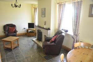 a living room with a couch and a fireplace at Seaview Self-Catering in Allihies