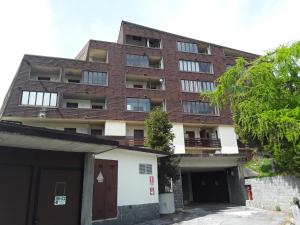 an apartment building with a parking garage in front of it at Residenza-Condominio Orsa Maggiore in Prato Nevoso