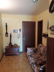 a living room with a couch and a table at Residenza-Condominio Orsa Maggiore in Prato Nevoso