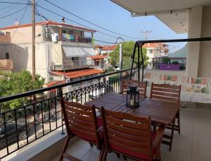 a balcony with a wooden table and chairs on a balcony at Magdalena & Bambino apartments in Sarti