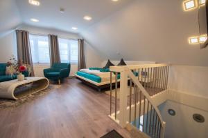 a living room with a bed and a staircase at Kleines Glück in Willingen &MeineCardPlus in Willingen