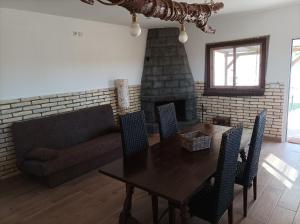 a living room with a table and a couch and a fireplace at Casa Noa in Huesca