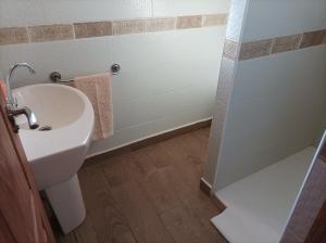 a bathroom with a sink and a toilet and a shower at Casa Noa in Huesca