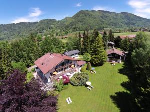 an aerial view of a large house in the mountains at Hotel Garni Sonnenhof in Rottach-Egern