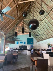 a restaurant with people sitting at tables in a room at Ocean view Aquamarina in Cancún