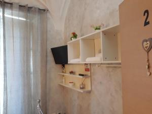 a bathroom with white cabinets and a shower at B&B Sotto gli archi in Catania