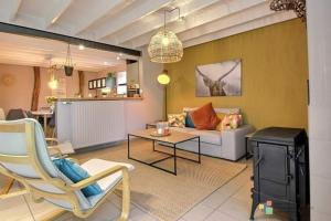 a living room with a couch and a table at Lî Gurni in Houffalize