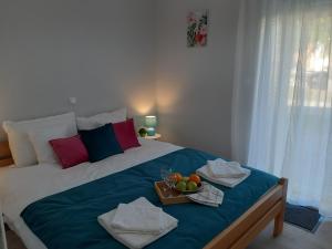a bedroom with a bed with a tray of fruit on it at Apartments Manna Palic in Palić +75 photos