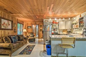 a kitchen and living room with a couch and a counter at Pet-Friendly One Crow Cottage in Harbor Springs! in Harbor Springs