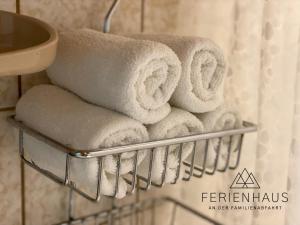 a bunch of towels on a towel rack in a bathroom at Gartenwohnung an der Familienabfahrt in Brixen im Thale