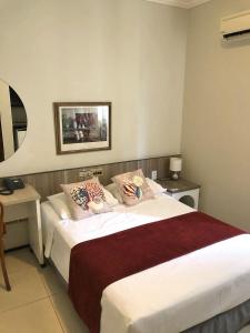 a hotel room with a large bed with pillows at Aldeota Praia Hotel in Fortaleza +42 photos
