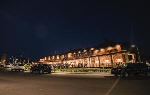 a building with cars parked in front of it at night at ГОдина ЩАстя in Hoshcha