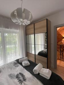 a bedroom with a large mirror and two pillows on a bed at Zielone Rozewie Park in Rozewie