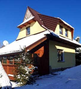 a house with snow on top of it at Domki u Hani 2 in Murzasichle