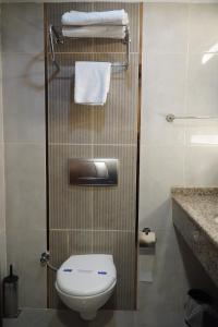 a small bathroom with a toilet and towels at Bern Hotel in Istanbul