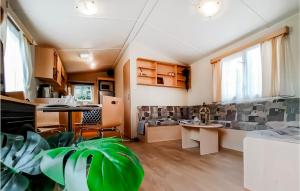 a living room with a couch and a table at 2 Bedroom Lovely Home In Heinkenszand in Heinkensand