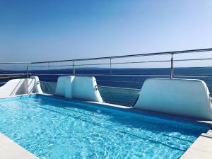 a swimming pool on the roof of a building at Relais La Ghinghetta in Portoscuso