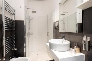 a bathroom with a sink and a toilet and a shower at Maison Piazza Cavour in Rome