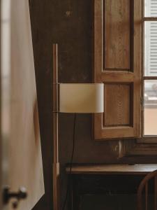a lamp in a kitchen next to a window at Numeroventi Design Residency in Florence