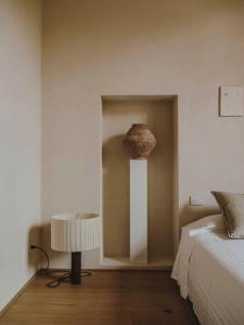 a bedroom with a bed and a vase on the wall at Numeroventi Design Residency in Florence