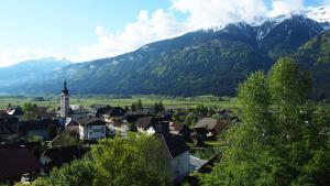a town in the mountains with a town and a church at Apartment Leitn in Kirchbach