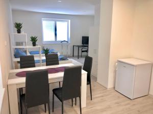 a kitchen and dining room with a table and chairs at Apartmány Zahrádky in Hráz