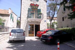 two cars parked in front of a building at Villa Ana Split in Split