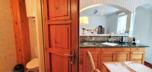 a kitchen with a sink and a counter with a table at Drevenička U Ježka in Ždiar +39 photos