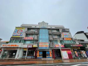 a tall building with signs on the side of a street at Hotel Ginsui - Vacation STAY 58206v in Kanayama