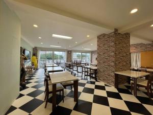 a restaurant with tables and chairs and a brick wall at Marina Hotel Kaikuu - Vacation STAY 58549v in Kanayama