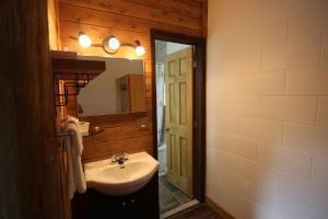 a bathroom with a sink and a mirror at Motel Lennoxville in Sherbrooke