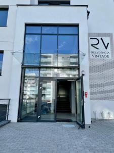 an entrance to a white building with glass doors at Rezydencja Vintage Exclusive Series in Olsztyn