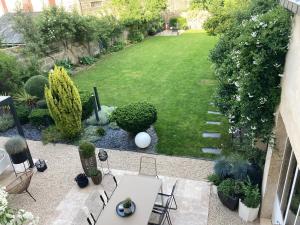 an aerial view of a garden with a lawn at la boutique mj décoration vous propose de découvrir ses deux chambres d'hôtes in Doué-la-Fontaine +18 photos