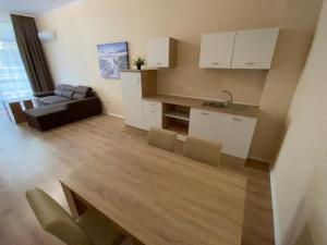 a kitchen and living room with a couch and a table at Rabi Park Residence in Varna City