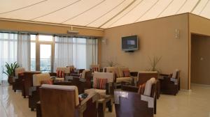 a waiting room with chairs and a tv on a wall at Al Khaima City Center in Nouakchott