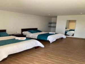 A bed or beds in a room at Hotel Takuara