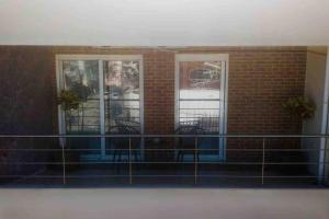 a balcony with two chairs in a brick building at Vasilikis design appartment in Amalias