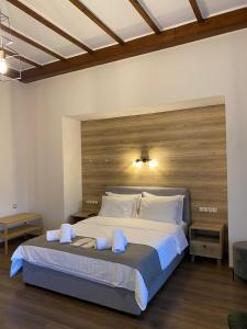 a bedroom with a large bed with a wooden headboard at 11 Luxury Apartments in Metsovo