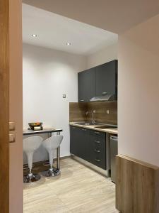 a kitchen with a table and two stools at 11 Luxury Apartments in Metsovo