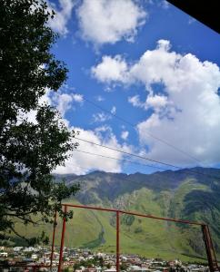 a view of a mountain range with a city at Belas guesthouse in Stepantsminda