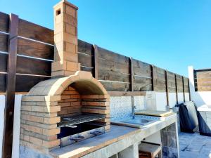 an outdoor brick pizza oven on a patio at Canary Wild House 2 in Carrizal